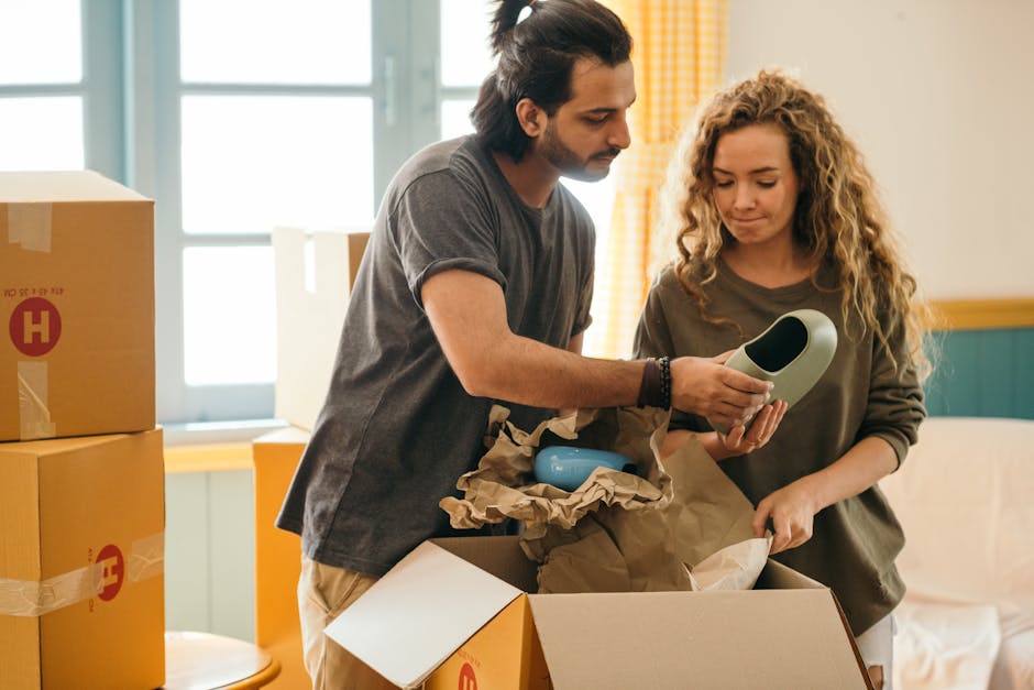 Movers providing packing services in a living room